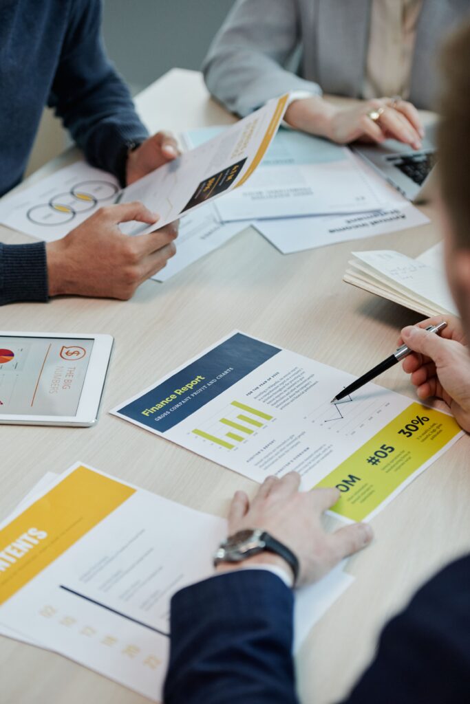 Business team reviewing financial reports and charts around a meeting table
